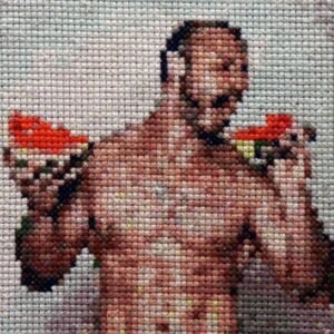 Double Fisting — original 4×4 inch hand-stitched cross-stitch of a bare-chested muscular man holding a large slice of watermelon in each hand, stitched in warm brown skin tones with vivid red-orange fruit against a cream background
